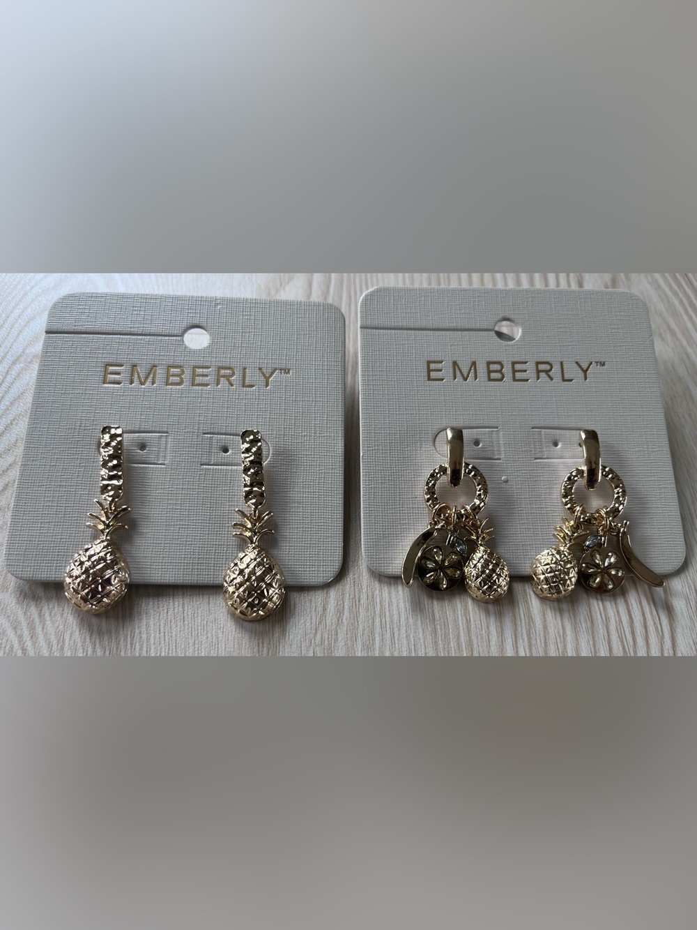 Emberly  Set of two beautiful earrings with Pineapple andFflower charms.